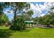 Community playground including covered area and swings on a sunny day with lush trees and blue sky at 4244 Reflections Pkwy, Sarasota, FL 34233