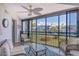 Screened waterfront balcony featuring beautiful views of the serene waterway and lush landscaping at 448 Gulf Of Mexico Dr # A204, Longboat Key, FL 34228