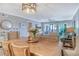 Open dining room area featuring wood floors, neutral walls, and a view into the bright living room at 448 Gulf Of Mexico Dr # A204, Longboat Key, FL 34228