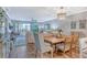 Cozy dining area with wood floors, an elegant chandelier, and a view of the waterfront balcony at 448 Gulf Of Mexico Dr # A204, Longboat Key, FL 34228