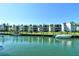 Condo exterior featuring private boat docks, lush landscaping, and a tranquil waterfront setting at 448 Gulf Of Mexico Dr # A204, Longboat Key, FL 34228