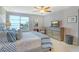 Comfortable main bedroom featuring a ceiling fan, water view, and decorative furnishings at 448 Gulf Of Mexico Dr # A204, Longboat Key, FL 34228