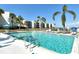 Swimming pool with palm trees and condos in the background at 448 Gulf Of Mexico Dr # A204, Longboat Key, FL 34228