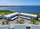 Aerial view of a three-story condo building with covered parking and beautiful bay views at 4722 Independence Dr, Bradenton, FL 34210