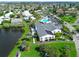 Aerial view featuring community amenities including a pool, clubhouse and lake with fountain at 4722 Independence Dr, Bradenton, FL 34210