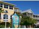 Two-story building with sign listing Clock Tower, boutiques, lodging, and restaurants at 4722 Independence Dr, Bradenton, FL 34210