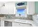 The kitchen sink has a view of the bay and the granite countertop is beautiful at 4722 Independence Dr, Bradenton, FL 34210