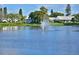 Scenic view of a tranquil lake featuring a decorative fountain, enhancing the community's peaceful ambiance at 4722 Independence Dr, Bradenton, FL 34210