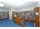 Library room with a large collection of books and comfortable furniture at 4722 Independence Dr, Bradenton, FL 34210