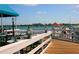 Waterfront pier with a blue awning, tables, chairs, and scenic ocean views at 4722 Independence Dr, Bradenton, FL 34210