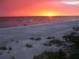 Beautiful beach sunset with silhouettes of people walking along the shore at 4722 Independence Dr, Bradenton, FL 34210