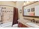 Bathroom featuring a shower-tub combo, granite countertops, and ample lighting at 4768 Tivoli Ave, Sarasota, FL 34235