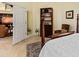 Spacious bedroom with four poster bed, adjacent living area and tile floors at 4768 Tivoli Ave, Sarasota, FL 34235