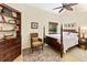 Bedroom featuring a four-poster bed, wooden furnishings, and a ceiling fan at 4768 Tivoli Ave, Sarasota, FL 34235