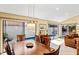 Well-lit dining area overlooking a pool, featuring a wooden table with seating for six and neutral decor at 4768 Tivoli Ave, Sarasota, FL 34235