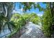 Gravel community walking path lined with native landscaping and a view of the lake at 4768 Tivoli Ave, Sarasota, FL 34235