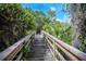 Community wooden bridge offering a scenic path through lush greenery at 4768 Tivoli Ave, Sarasota, FL 34235