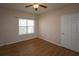 Bedroom features a ceiling fan, wood-look flooring, a window, and a closet door at 4802 51St W St # 613, Bradenton, FL 34210