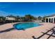 Large community swimming pool with surrounding patio and lounge chairs on a clear day at 4802 51St W St # 613, Bradenton, FL 34210