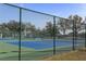 Green and blue tennis courts with a tall net at 4802 51St W St # 613, Bradenton, FL 34210