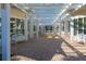 Bright walkway featuring white pillars, benches, and a decorative brick pathway at 4802 51St W St # 613, Bradenton, FL 34210