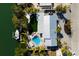 Aerial view of house featuring a backyard pool, lush landscaping, and waterfront access at 505 65Th St, Holmes Beach, FL 34217