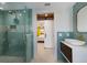 Well-lit bathroom featuring modern tiling, walk-in shower, and bedroom access at 505 65Th St, Holmes Beach, FL 34217