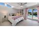 Bedroom featuring a skylight, ceiling fan, access to the outdoor pool, and colorful accents at 505 65Th St, Holmes Beach, FL 34217