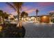 Charming home featuring a gravel front yard, palm trees, modern lighting and a wood accent wall at 505 65Th St, Holmes Beach, FL 34217