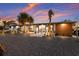 Charming home featuring a gravel front yard, palm trees, modern lighting and a wood accent wall at 505 65Th St, Holmes Beach, FL 34217