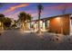 Charming home featuring a gravel front yard, palm trees, modern lighting and a wood accent wall at 505 65Th St, Holmes Beach, FL 34217