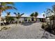 Beautifully landscaped home with mature palms and a circular drive at 505 65Th St, Holmes Beach, FL 34217