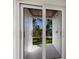 An outdoor shower area framed by sliding glass doors with access to a manicured lawn at 505 65Th St, Holmes Beach, FL 34217