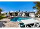 Inviting pool area featuring brick pavers, lounge chairs, and outdoor dining for upscale backyard enjoyment at 505 65Th St, Holmes Beach, FL 34217