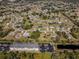 An aerial view of a community, showing various houses, roads, and green spaces at 514 Santiguay St, Punta Gorda, FL 33983