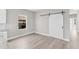 Kitchen dining area with white barn door and wood-look flooring at 514 Santiguay St, Punta Gorda, FL 33983