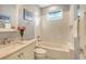 Cozy bathroom featuring a tub, a large mirror, light gray walls, and a marble sink and countertop at 515 S Osprey Ave, Sarasota, FL 34236