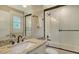 Bathroom featuring granite countertops, a glass door shower, and bright natural light at 515 S Osprey Ave, Sarasota, FL 34236