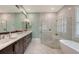 Modern bathroom featuring a double vanity, large mirror, glass shower, and a separate soaking tub at 515 S Osprey Ave, Sarasota, FL 34236