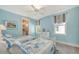 Charming bedroom with two twin beds, soft blue walls, and decoratively draped windows at 515 S Osprey Ave, Sarasota, FL 34236