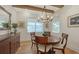 Elegant dining room with hardwood floors, wood-beam ceilings and stylish chandelier at 515 S Osprey Ave, Sarasota, FL 34236