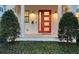 Inviting front entryway highlighting the bright red door, sconces, and decorative shrubbery at 515 S Osprey Ave, Sarasota, FL 34236