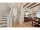 Hallway featuring hardwood floors, white trim, and a staircase leading upstairs at 515 S Osprey Ave, Sarasota, FL 34236