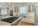 Well-lit kitchen featuring stainless steel appliances, a center island, and white cabinetry, perfect for cooking at 515 S Osprey Ave, Sarasota, FL 34236