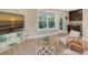 Living room with a mounted television, two cushioned chairs, and a serving area with dark wood cabinets at 515 S Osprey Ave, Sarasota, FL 34236