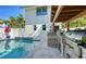 Exterior view of the outdoor kitchen, pool, and backyard at 515 S Osprey Ave, Sarasota, FL 34236