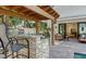 Outdoor kitchen area with a built-in grill, a bar, patio furniture, and views of the home's interior at 515 S Osprey Ave, Sarasota, FL 34236