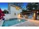 Backyard pool with an outdoor kitchen and grill, surrounded by a tiled patio area for entertaining guests at 515 S Osprey Ave, Sarasota, FL 34236