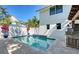 Private pool surrounded by a travertine deck, landscaping, and an outdoor kitchen area at 515 S Osprey Ave, Sarasota, FL 34236