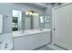 Bathroom with dual sinks, large mirror, and a separate door for added privacy at 5251 Mahogany Run Ave # 526, Sarasota, FL 34241